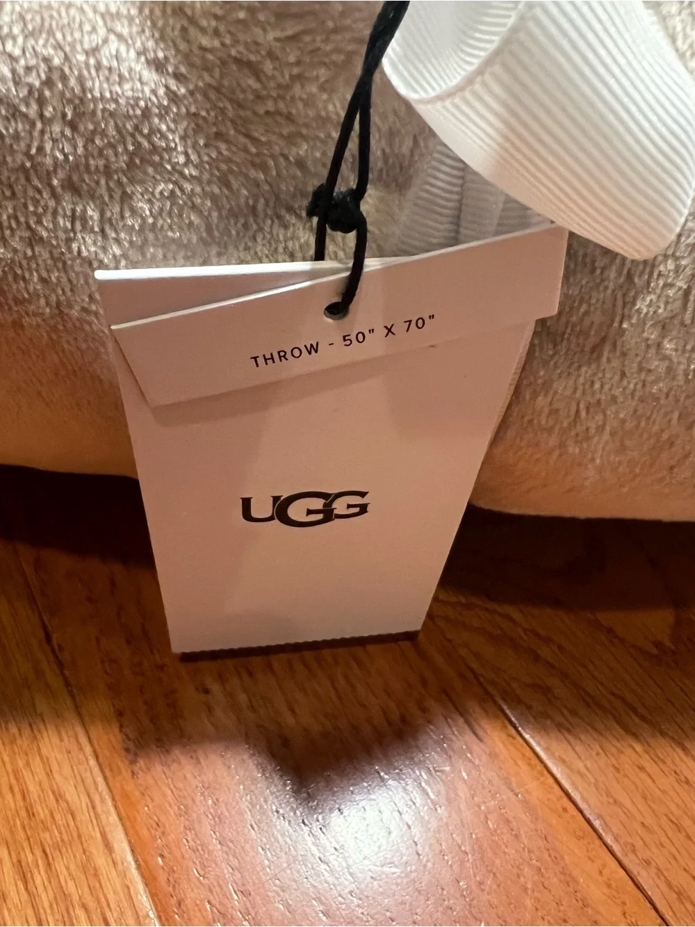 UGG Plush Throw in Light Beige with White Ribbon
